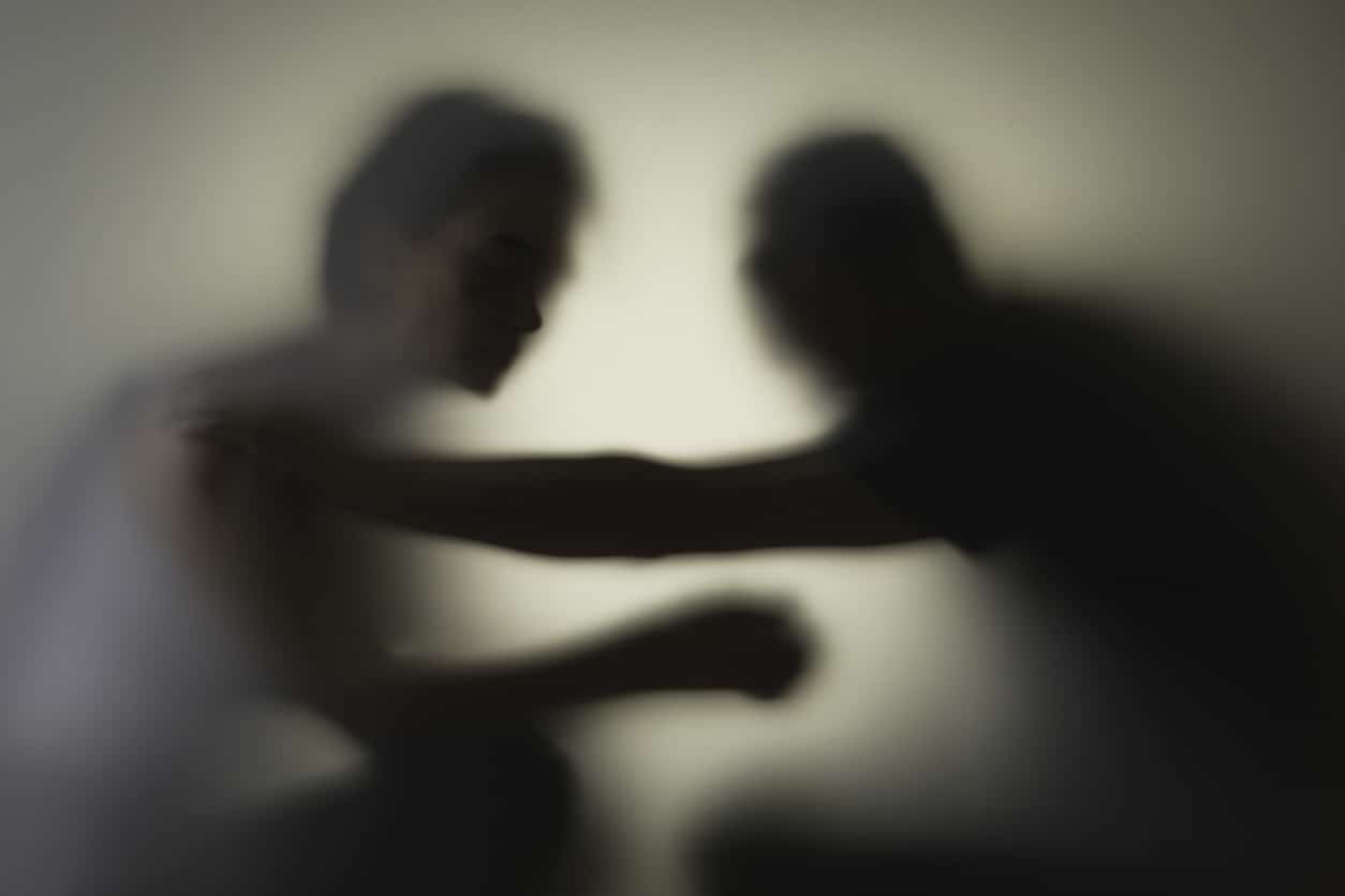Unrecognizable sad woman and man in silhouette. Relationship problems concept.
