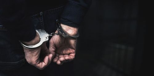 person in handcuffs