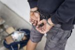 drug smuggler in cuffs concept