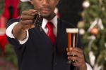 African American handing over car keys while drinking