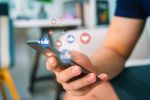 man using smart phone with Social media icons